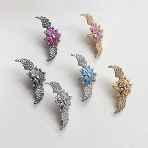 Colorful zircon-set winged shield studs in gold and silver plating with enamel center