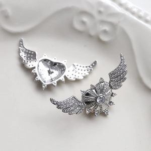 Detailed view of silver heart earrings with angel wings and micro-paved cubic zirconia