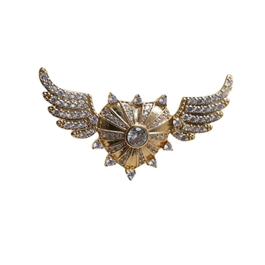 Golden heart wing shield brooch with sparkling cubic zirconia in baroque style