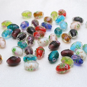 Macro shot of assorted floral glass beads with gold foil for DIY jewelry making