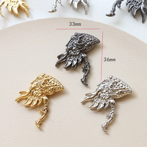 Detailed view of dragon-shaped jewelry charms with cubic zirconia in three metal finishes