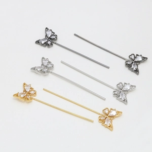 Detail of gold and silver butterfly hairpins featuring cubic zirconia and ornate hollow design