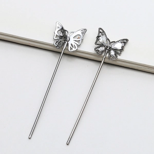 Detail of silver butterfly hair pin with zircon butterfly top and hollow metal design