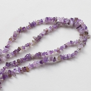 Macro view of irregular natural purple amethyst stone beads for DIY jewelry making