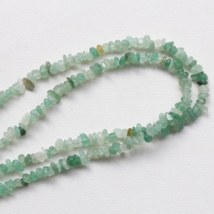 Detailed view of irregular green aventurine gemstone chips for DIY jewelry making