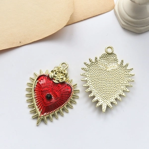 Macro shot of heart-shaped red enamel pendant with eye motif and rose detail