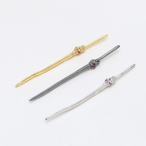 Set of three sword-shaped metal pendants with red gemstones for DIY jewelry making