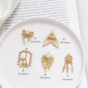 Macro view of assorted golden pearl pendants with sizes like 26x21mm for DIY jewelry
