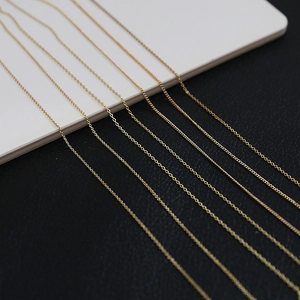 Detailed close-up of various 14k gold plated chain styles for DIY jewelry making