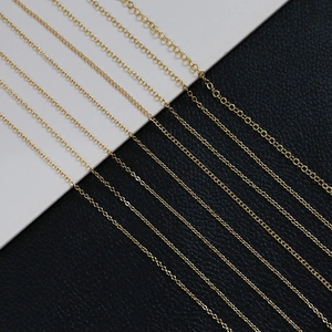 Macro shot of 14k gold plated flat O-chain and cross chain varieties for DIY jewelry