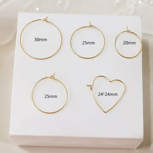Detailed view of 14k gold plated hoop earrings in heart and round shapes with size specs