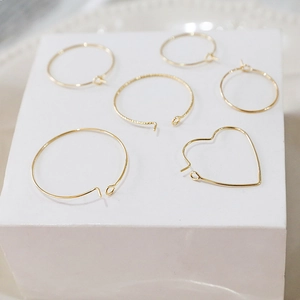 Macro shot of 14k gold-filled round and heart-shaped earring hoops for DIY jewelry making