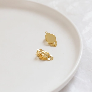 Detail of 14k gold-plated spring clip earrings with flat base for DIY jewelry making