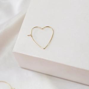 Close-up of minimalist 14k gold heart-shaped hoop earring for DIY jewelry making