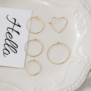 5-piece set of 14k gold-filled earrings including heart and textured hoop designs