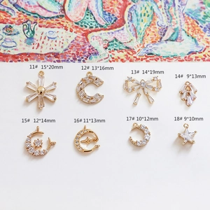 Detailed view of 18k gold plated DIY jewelry charms with cubic zirconia star and moon designs