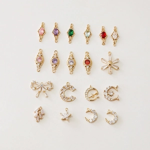 Macro detail of various 18k gold plated charms with colorful zircon for DIY jewelry making