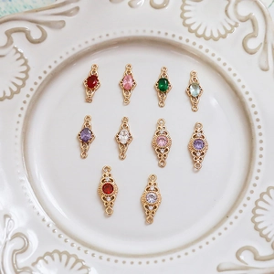 Close-up of 10-piece 18k gold-plated retro jewelry connectors with colorful gemstones