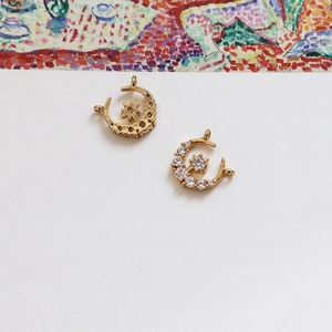 Detail of 18k gold plated moon and star pendants with white zircon for DIY jewelry