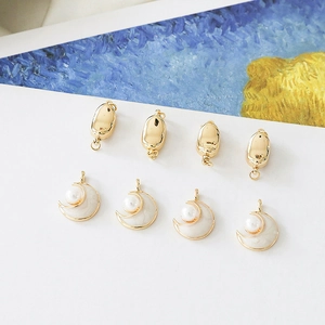 Artistic detail of gold crescent moon charms and oval connectors for DIY jewelry making