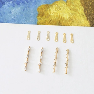 Macro shot of S925 sterling silver DIY connectors and zircon pendants on white background