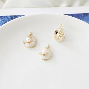 Detail of moon-shaped pearl charms with gold plating for DIY jewelry making