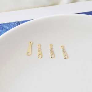 Detailed macro view of S925 sterling silver gold plated connector links with 925 stamps