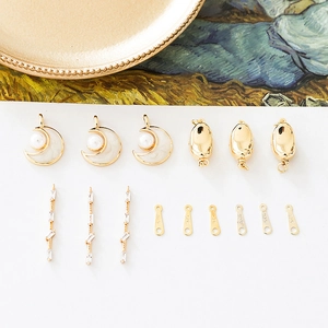 DIY jewelry set with gold moon pearls, zircon bars, and 925 charms on an elegant background