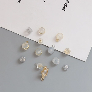 Close-up of silicone earring backs and gold-plated findings for DIY jewelry making