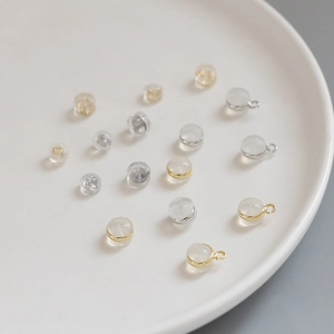 Detailed macro of transparent jewelry beads with gold and silver metal ring attachments
