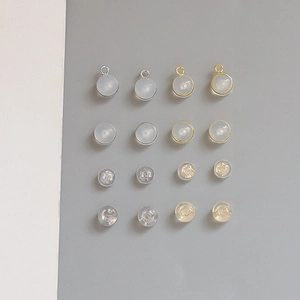 Mix of gold and silver earring backs with clear silicone pads and loop attachments