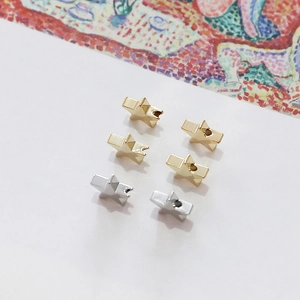 Detailed view of gold and silver five-pointed star beads for DIY jewelry making