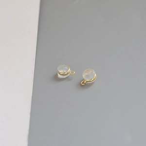 Detail of DIY earring pendants with gold plating and translucent round gemstone drops