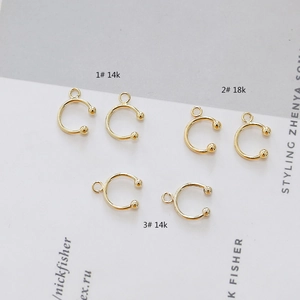 Detail of 14k and 18k gold-plated C-shaped ear cuff jewelry findings for DIY crafts