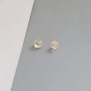 Close-up of clear silicone earring backs with premium gold-plated copper core for DIY jewelry