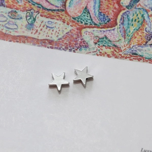 Detailed view of polished 14k white gold star-shaped DIY jewelry charms and studs