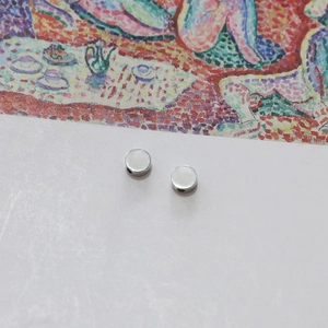 Macro view of silver circular metal spacer beads with side holes for DIY jewelry making