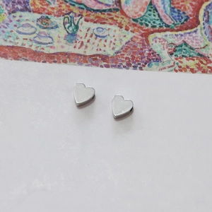 Detailed macro view of polished heart-shaped 14k white gold DIY jewelry components