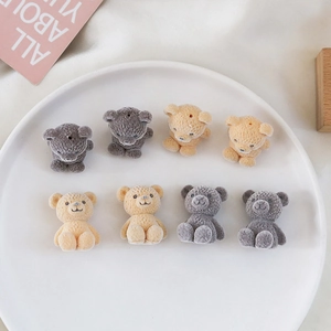 Detail of cute flocked teddy bear charms in grey and beige for DIY accessories