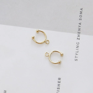 Golden C-shaped ear cuff DIY accessory with bead detail and small hanging loop