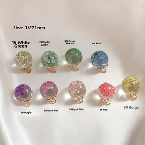 Close-up of 16x21mm glass ball charms with dried flowers for DIY jewelry making
