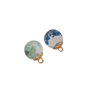 Transparent glass sphere pendants with dried flowers and golden metal hanging loops