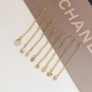 Detailed view of 14k gold plated S925 silver extension chains with flower heart charms