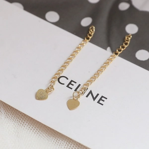 Macro detail of 14k gold plated heart charm and extension chain with S925 hallmark