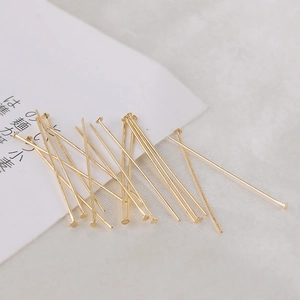 Macro shot of 14k gold plated flat head T-pins for DIY jewelry making and beading
