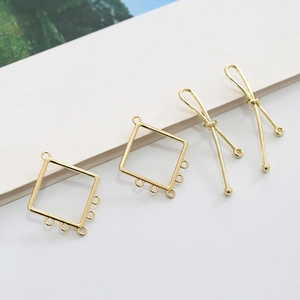 Detailed macro view of gold-plated hollow square and knot charms for DIY jewelry making