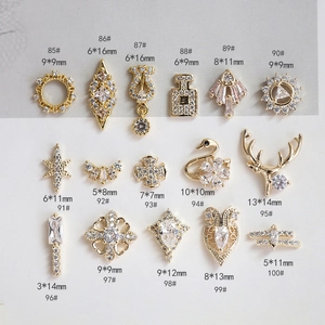 Detailed close-up of luxury swan and wreath nail art charms with sparkling zircons