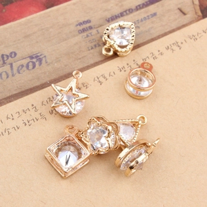 Detailed view of DIY jewelry charms in star, heart, and geometric shapes with cubic zirconia