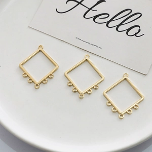 Detail of gold plated rhombic connectors with five loops for DIY earring and jewelry making