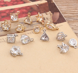 Detailed view of various geometric zircon pendants in star, heart and square shapes